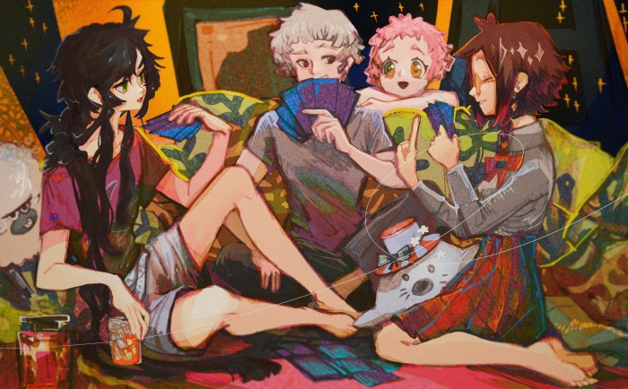 Four friends playing cards on a couch