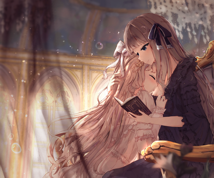 Two girls reading a book in a room
