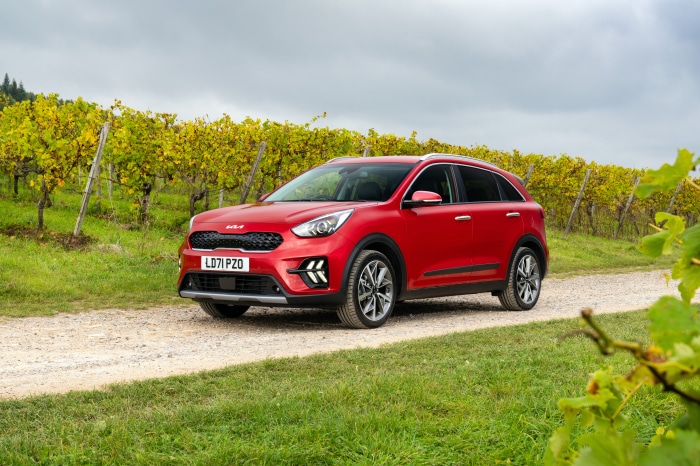 Red Kia Niro EcoHybrid SUV on a dirt road