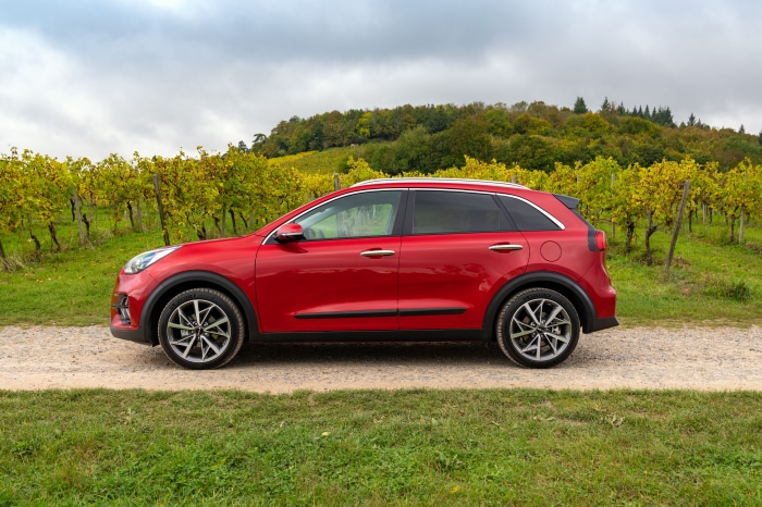 Red Kia Niro EcoHybrid SUV parked on a dirt road
