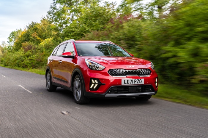 Red Kia Niro EcoHybrid SUV driving on a road