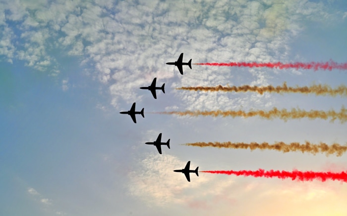 Air show with planes releasing colored smoke
