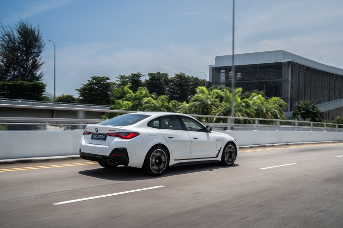 White BMW M440i xDrive Gran Coupé driving on road