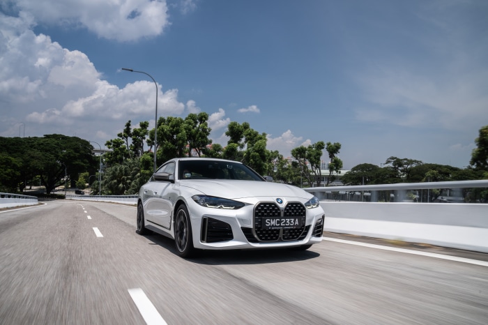 White BMW M440i xDrive Gran Coupé driving on a road