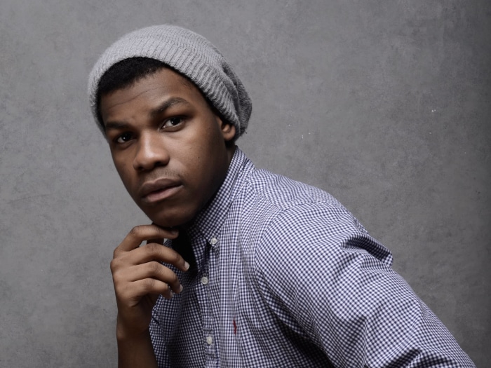 John Boyega wearing a grey beanie and checkered shirt