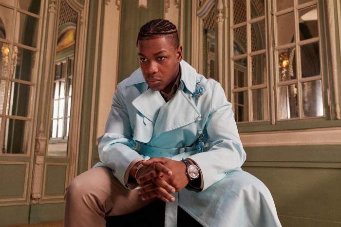 John Boyega in a light blue trench coat