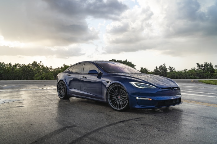 Blue Tesla Model S on Wet Road