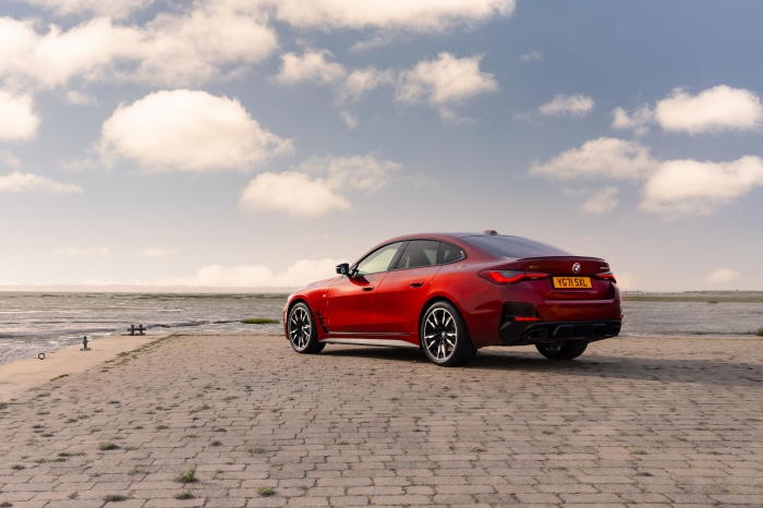Red BMW M440i xDrive Gran Coupé by the water