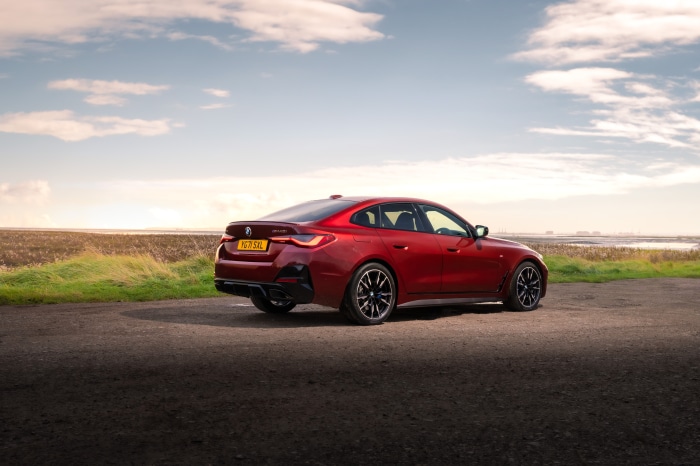 Red BMW M440i xDrive Gran Coupé on a road