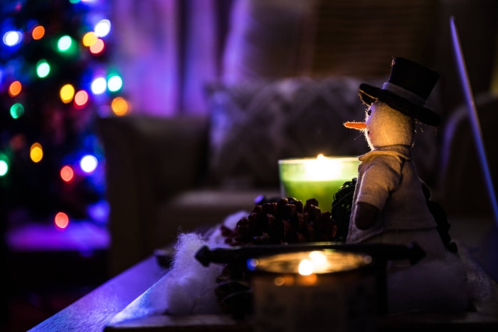 Snowman decoration with Christmas lights and candles