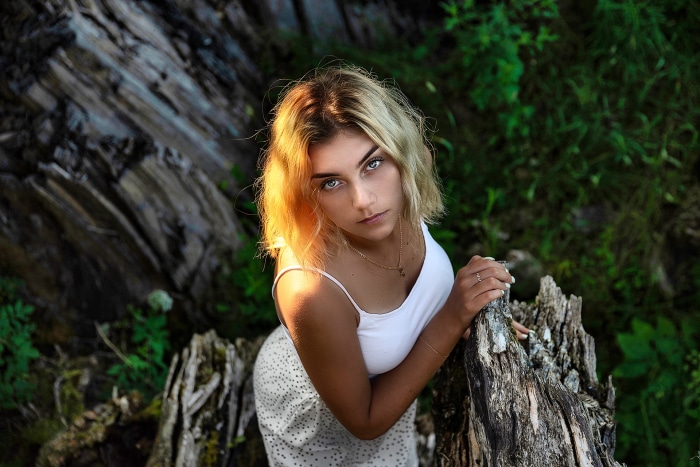 Young woman with blonde hair in a white top