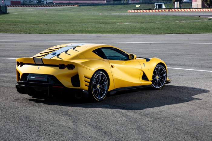 Yellow Ferrari 812 Competizione on a Racetrack