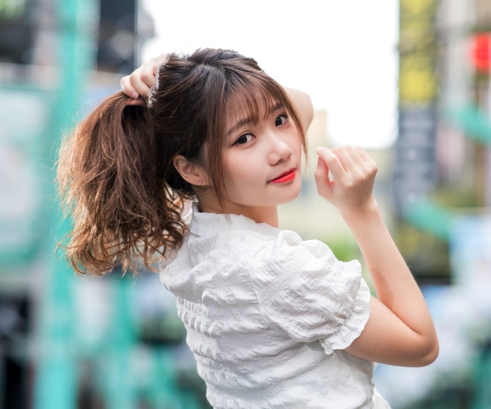 Young Asian woman with brown hair in a ponytail