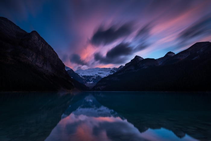 Lake Louise at dusk with mountains and clouds