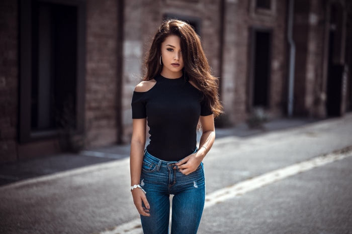 Woman in black top and jeans