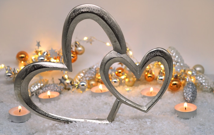 Heart-shaped sculpture with candles and Christmas lights