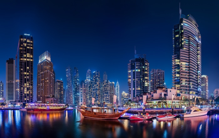 Dubai Marina skyscrapers and boats at night