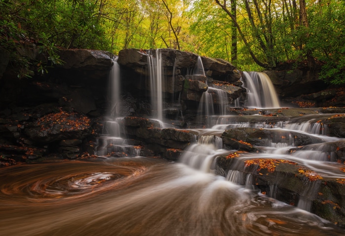 Waterfall in a forest with autumn leaves