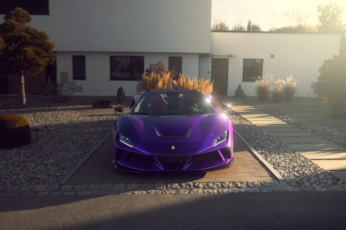 Purple Ferrari F8 Spider parked in front of a modern house