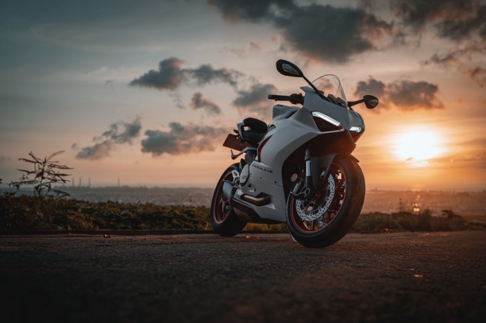 White Ducati Panigale V2 motorcycle at sunset