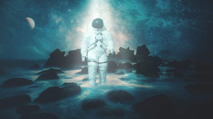 Astronaut standing in water under starry sky