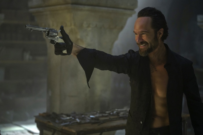 Chris Diamantopoulos holding a revolver
