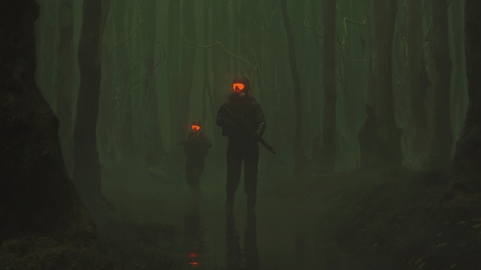 Two soldiers with orange goggles in a dark forest