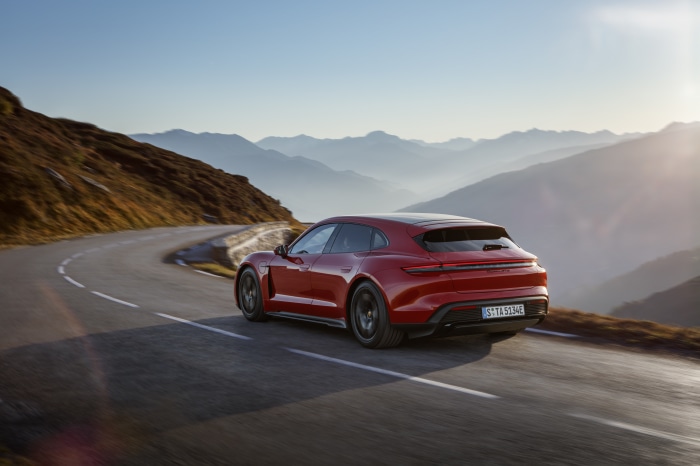 Red Porsche Taycan GTS Sport Turismo on mountain road