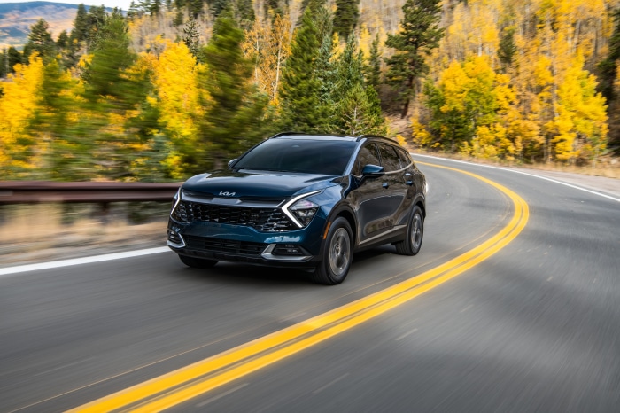 Dark Blue Kia Sportage HEV SUV on a winding road