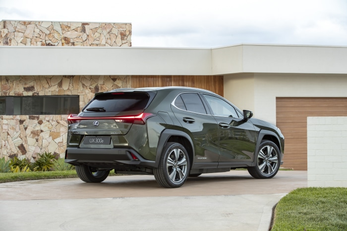 Lexus UX 300e SUV parked near a modern house