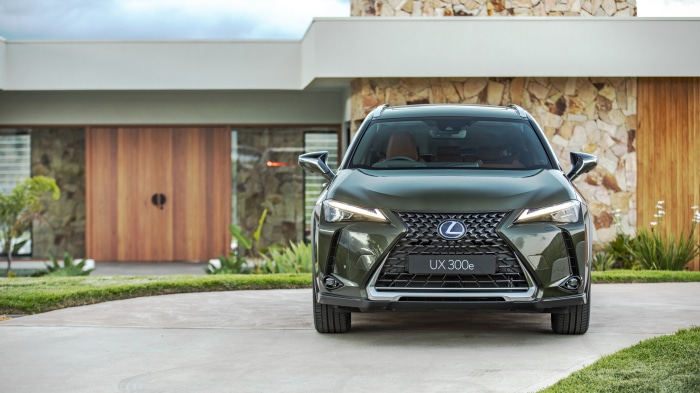 Lexus UX 300e SUV parked in front of modern house