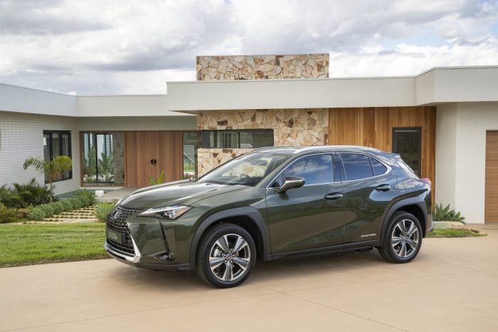 Lexus UX 300e SUV parked in front of a modern house