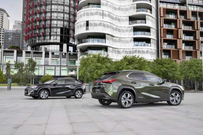 Two Lexus UX 300e SUVs parked in an urban setting