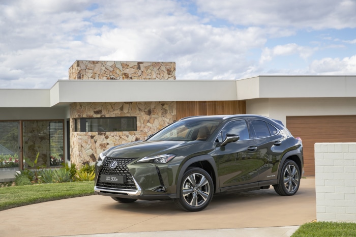 Lexus UX 300e SUV parked in front of a modern house