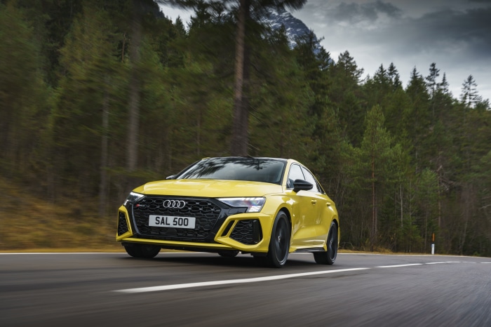 Yellow Audi RS3 Sedan driving on a road