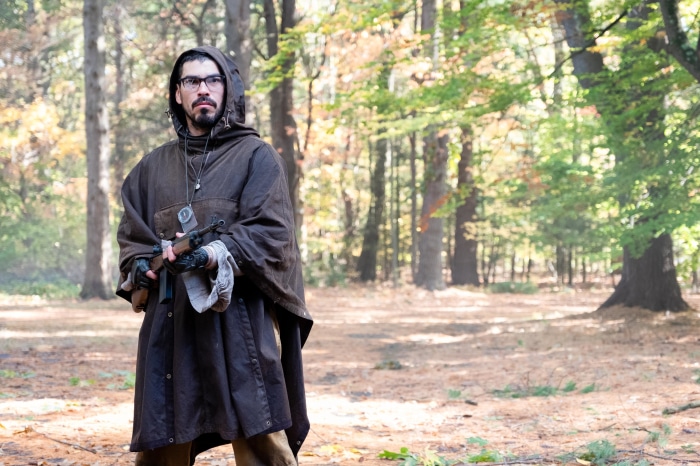 Man with gun in forest