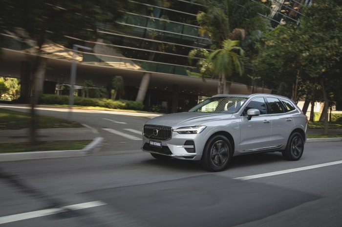 Silver Volvo XC60 T8 Recharge driving on a road
