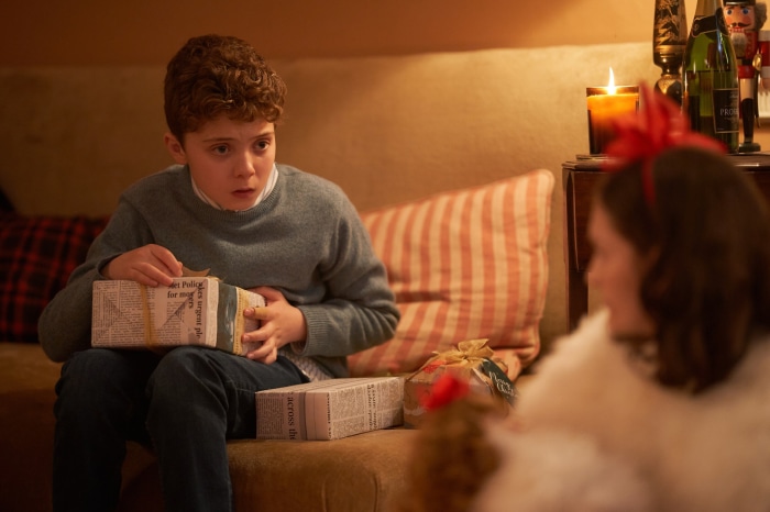 Boy opening gifts on Christmas