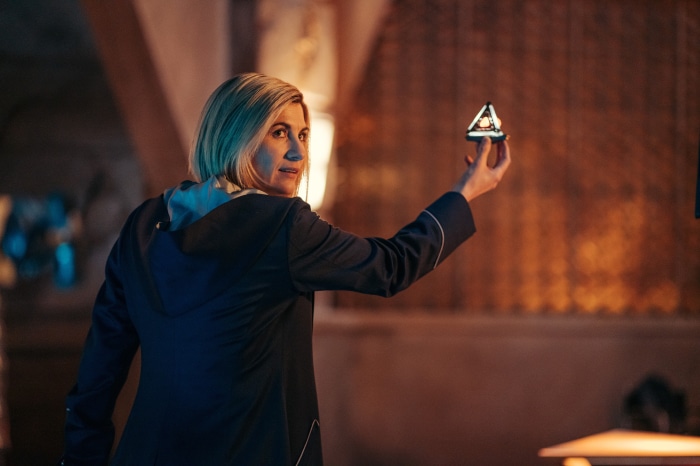 Thirteenth Doctor from Doctor Who holding a device