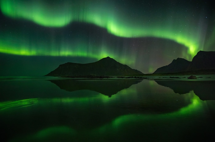 Aurora Borealis Reflection Over Mountains and Beach