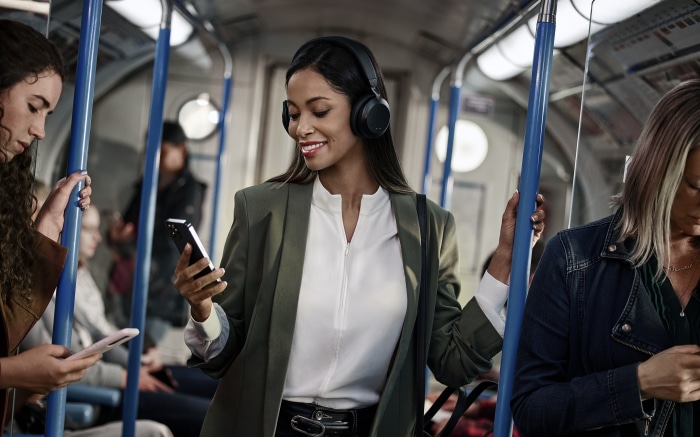 Woman wearing headphones on a subway