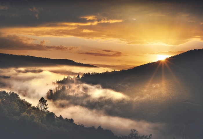 Sunset over a foggy valley with mountains