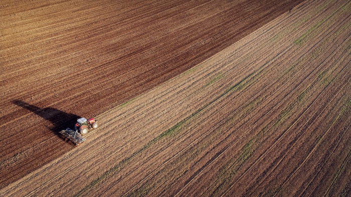 Tractor plowing a field from above