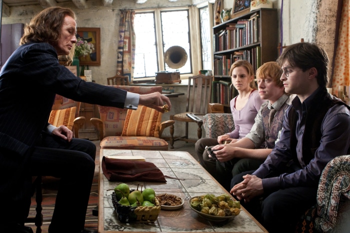 Rufus Scrimgeour gives a ring to Harry Potter, Ron Weasley, and Hermione Granger