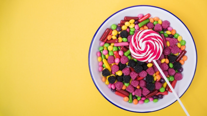 Bowl of assorted candies and a lollipop