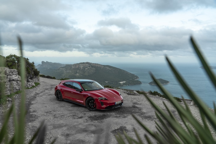 Red Porsche Taycan GTS Sport Turismo on mountain road