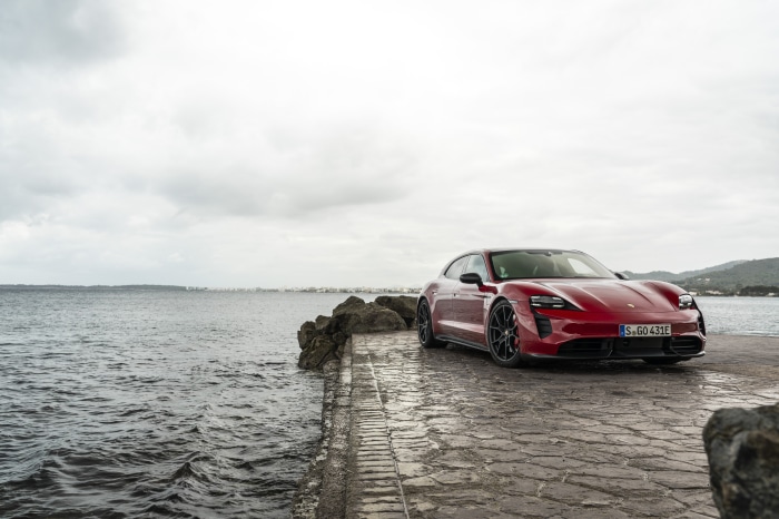 Red Porsche Taycan GTS Sport Turismo by the sea