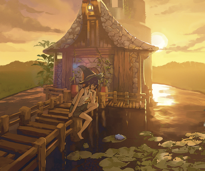 Girl in witch hat sitting on a dock at sunset