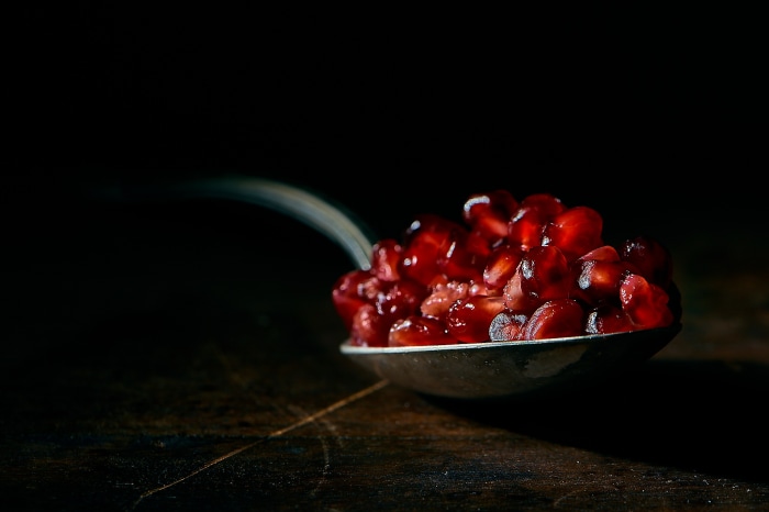 Pomegranate seeds on a spoon