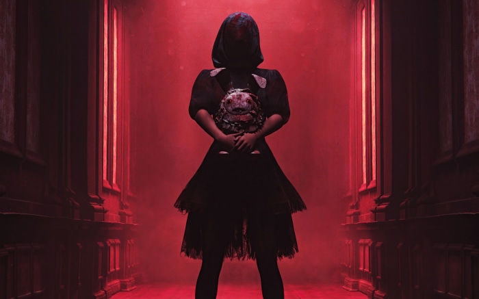 Creepy woman in dark dress holding a doll